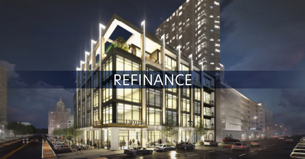 "Refinance" Overlaid onto a Building at Night